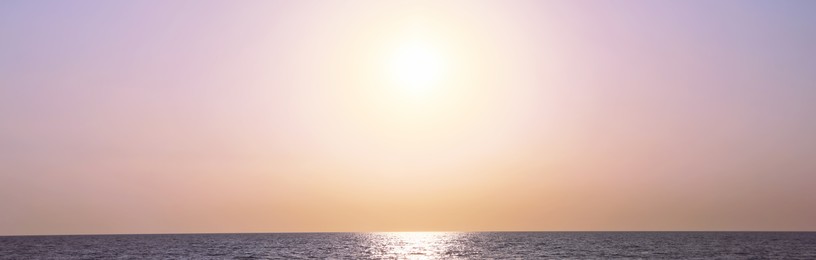 Image of Beautiful panorama of sky over sea at sunset. Banner design