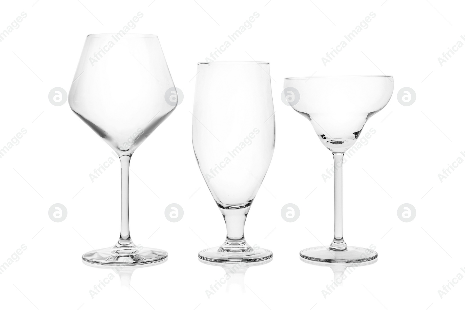 Photo of Set of empty glasses for different drinks on white background