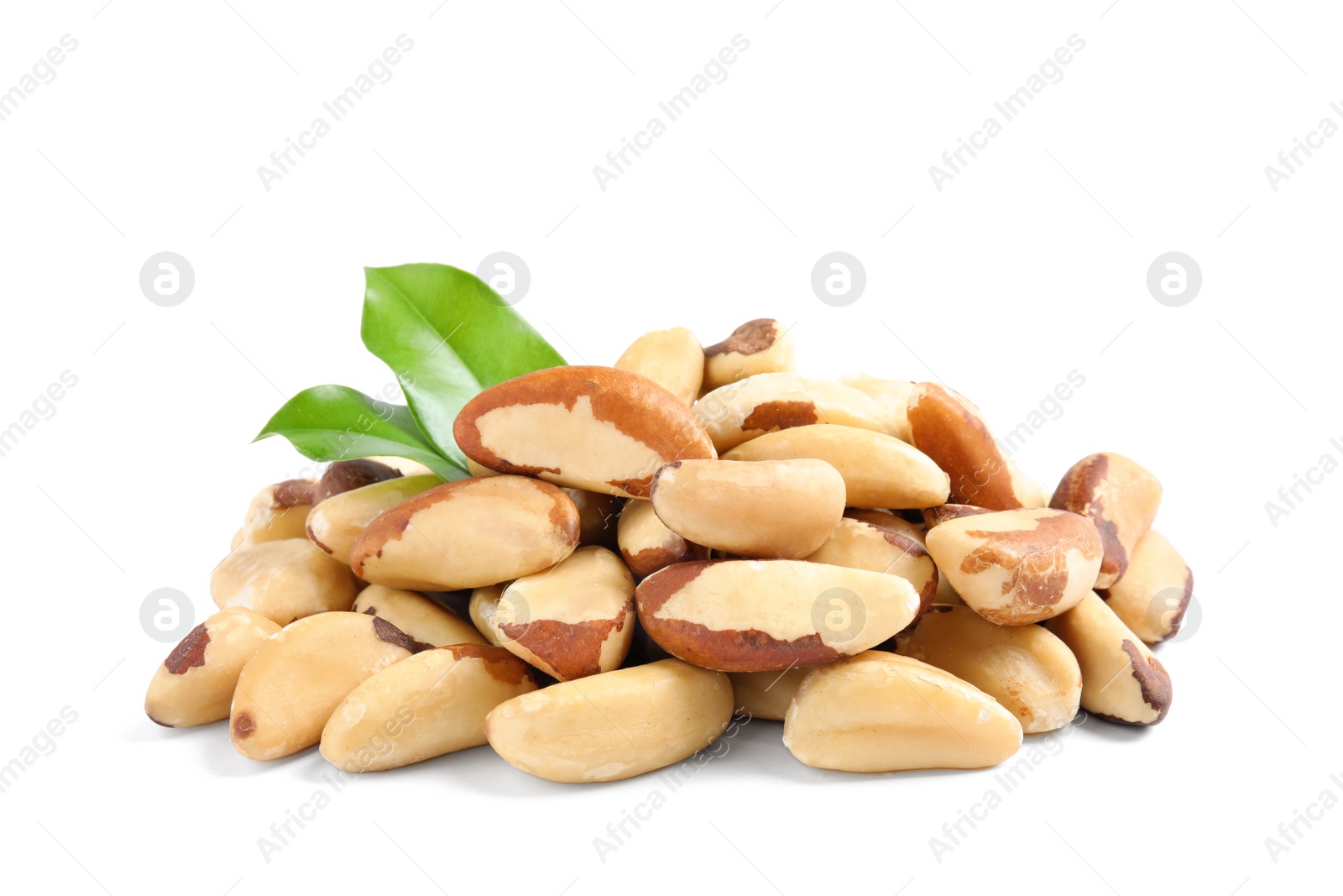 Photo of Brazil nuts with green leaves on white background