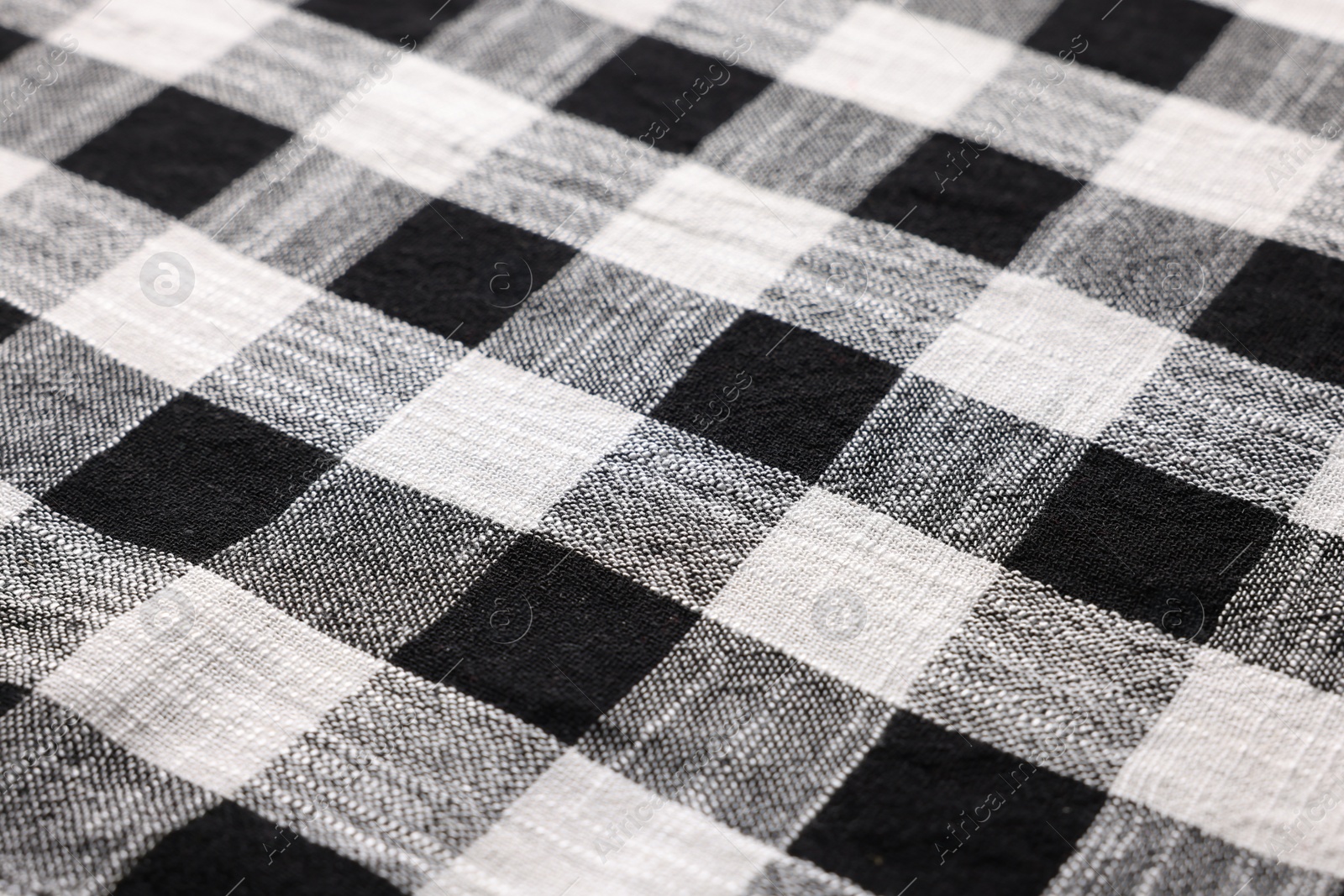 Photo of Black checkered tablecloth as background, closeup view