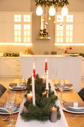 Festive table setting and beautiful Christmas decor in kitchen. Interior design