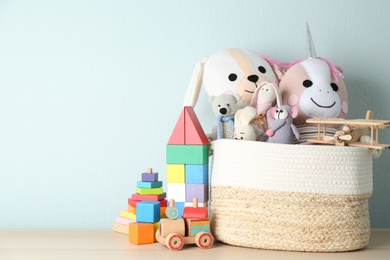 Photo of Set of different toys on wooden table. Space for text