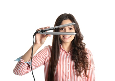 Young woman with modern hair iron on white background