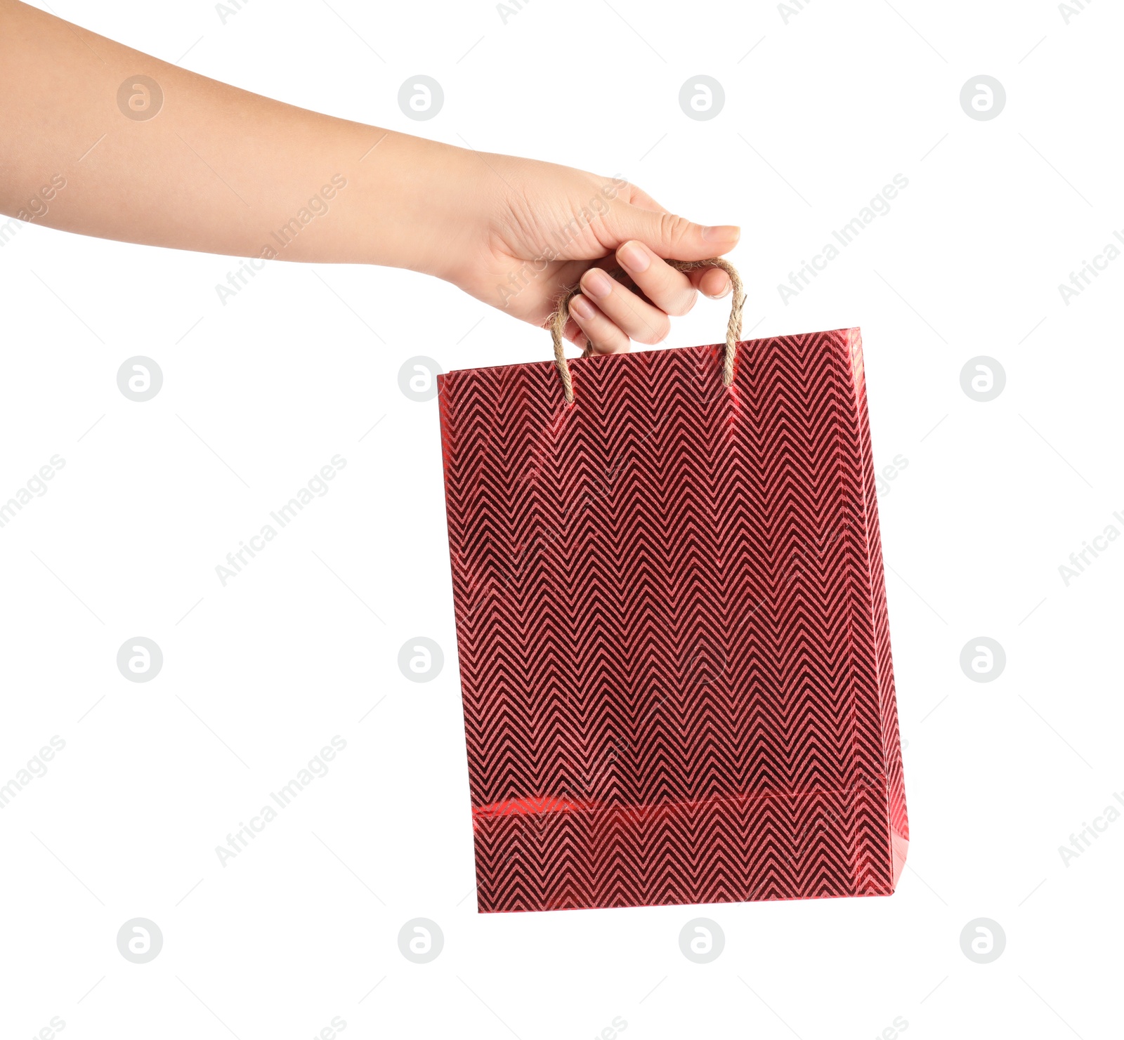 Photo of Woman holding red paper shopping bag on white background, closeup. Space for design