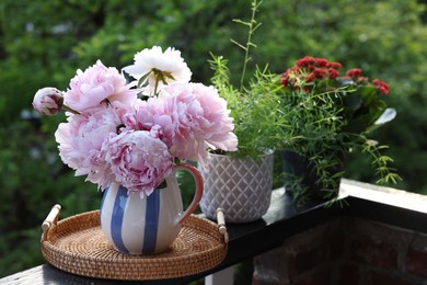 Photo of Balcony garden. Different plants growing on railings outdoors