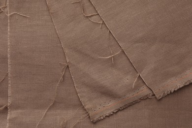 Texture of brown fabric as background, top view