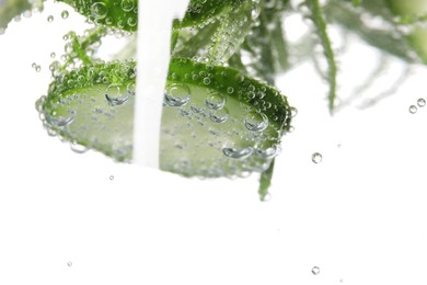 Refreshing cucumber water with bubbles isolated on white, closeup