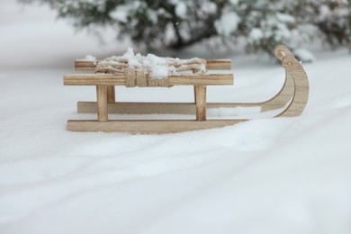 Beautiful decorative wooden sleigh on snow outdoors