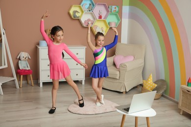 Photo of Cute little girls taking online dance class at home