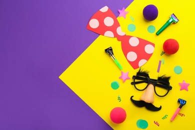 Photo of Flat lay composition with clown's accessories on color background. Space for text