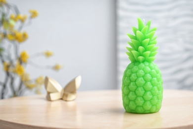 Pineapple shaped candle on table in room