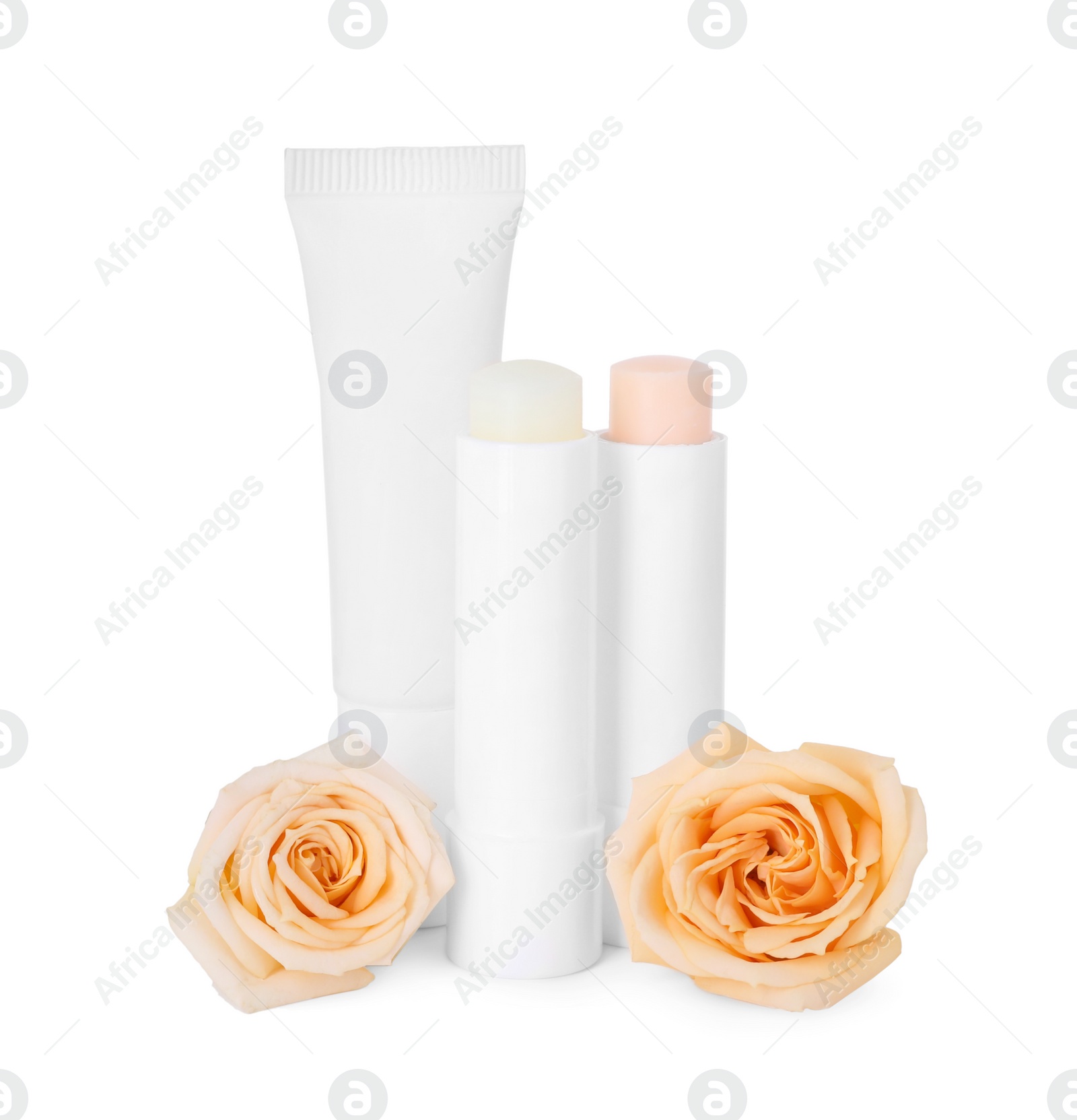 Photo of Lip balms and roses isolated on white