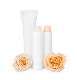 Photo of Lip balms and roses isolated on white