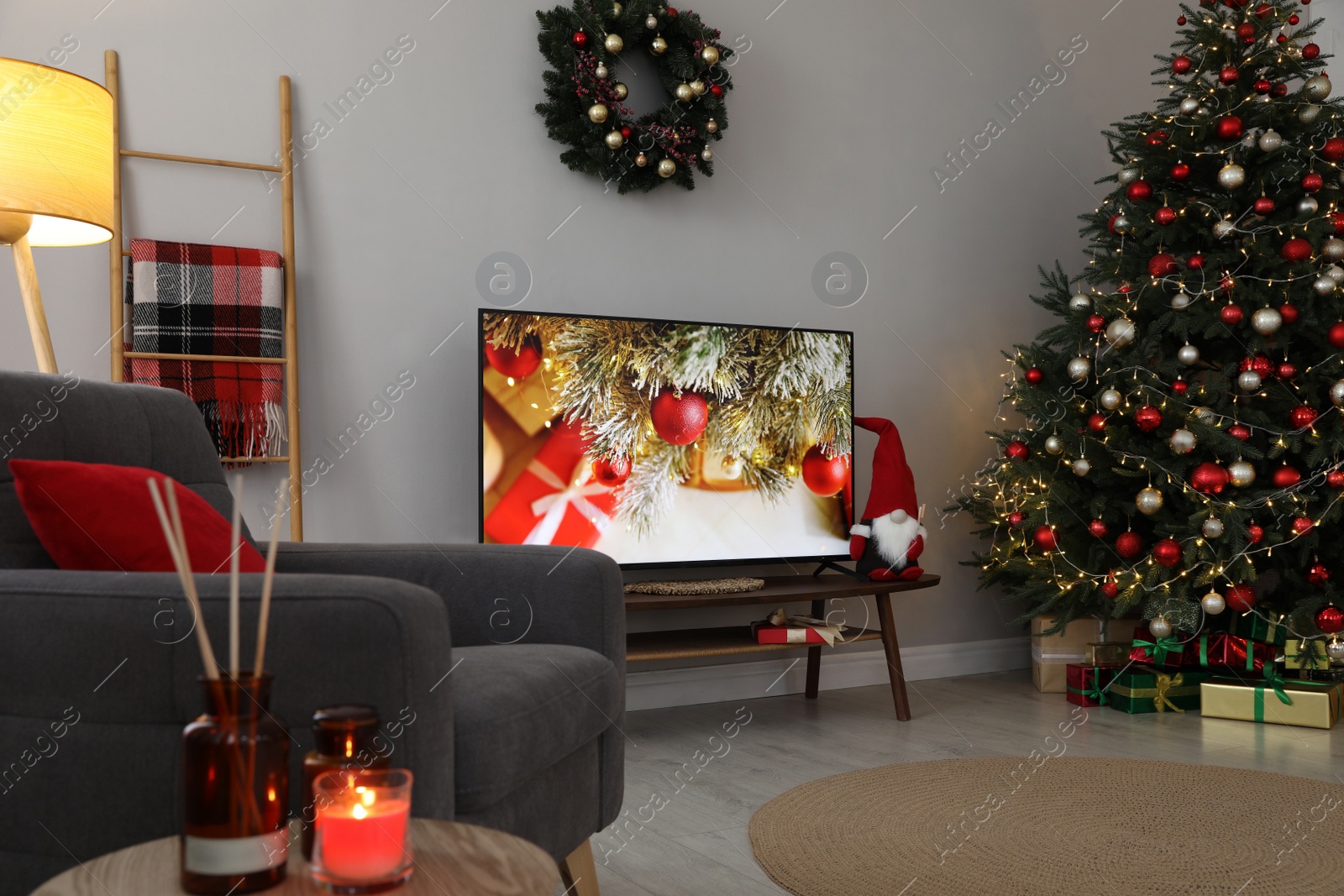 Photo of Stylish living room interior with modern TV and Christmas tree