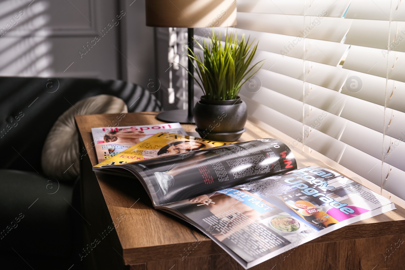 Photo of Different lifestyle magazines on chest of drawers indoors