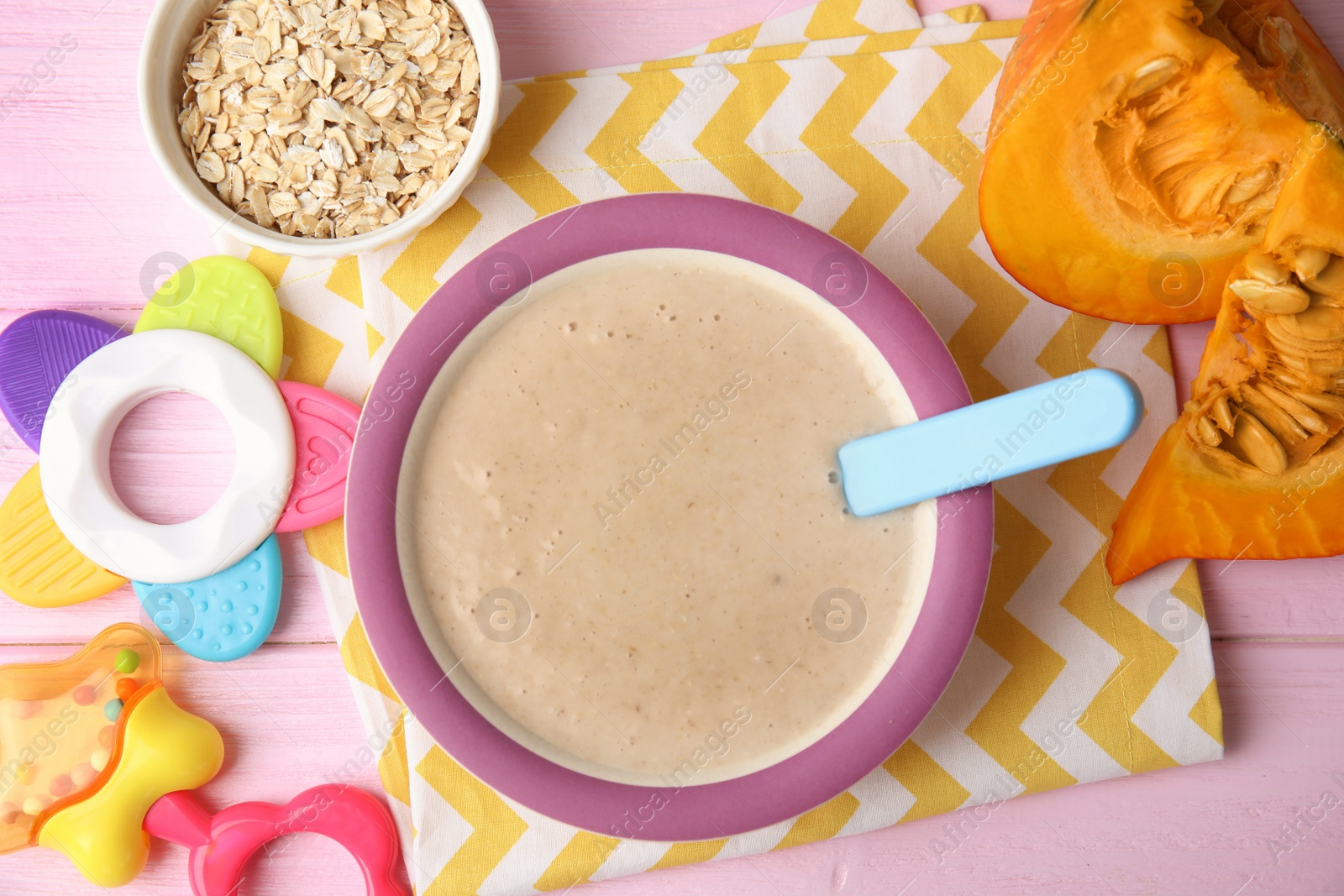 Photo of Flat lay composition with plate of healthy baby food on color background