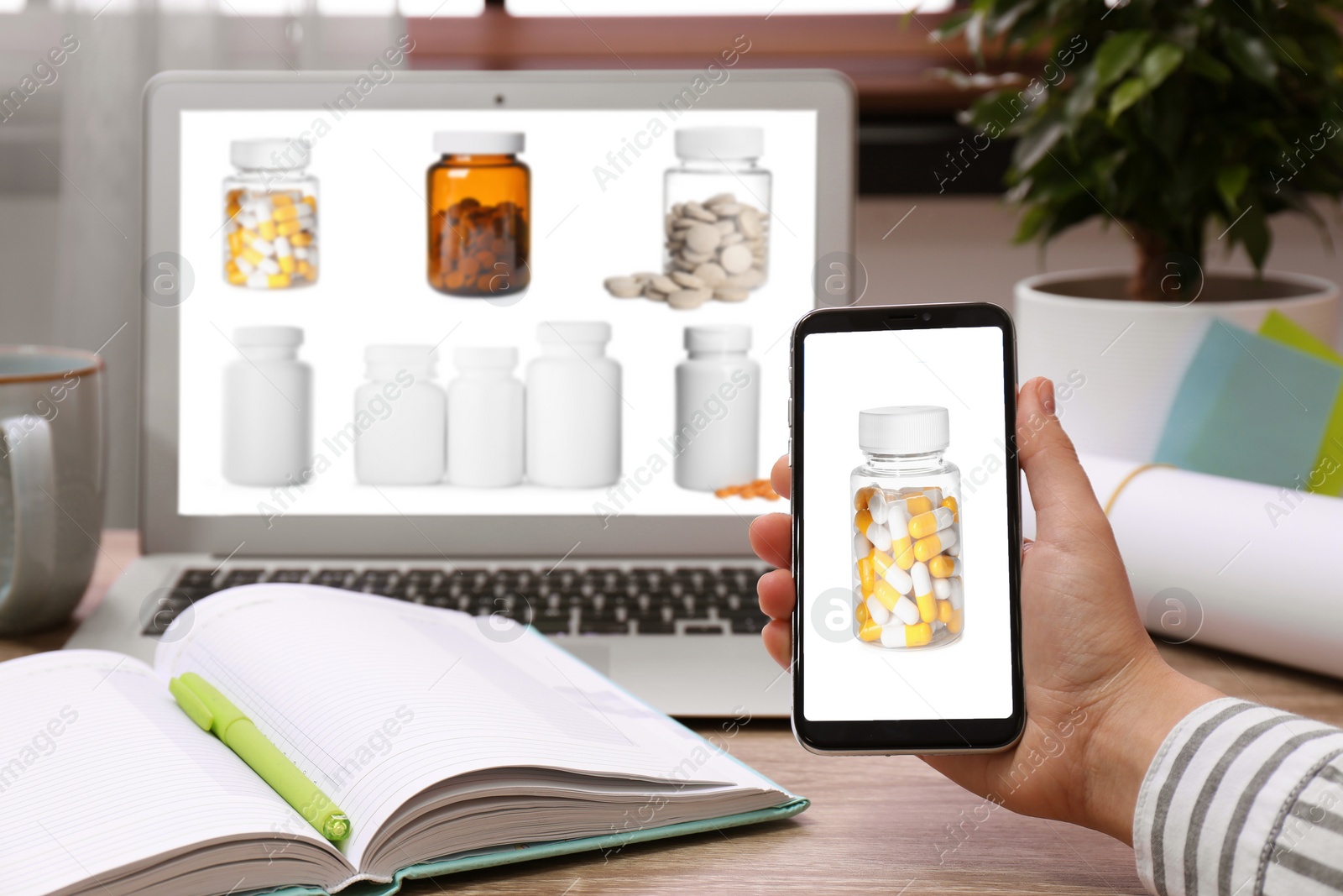 Image of Woman with smartphone and laptop ordering medications online, closeup