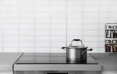 Photo of Casserole pot on electric stove in kitchen