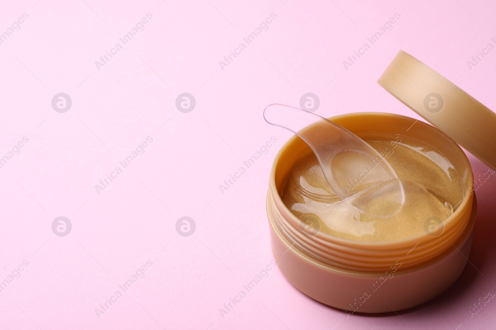 Photo of Package of under eye patches on pink background, space for text. Cosmetic product