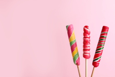 Bright yummy candies on color background. Space for text