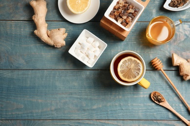 Photo of Composition with lemon tea on wooden background, top view. Space for text