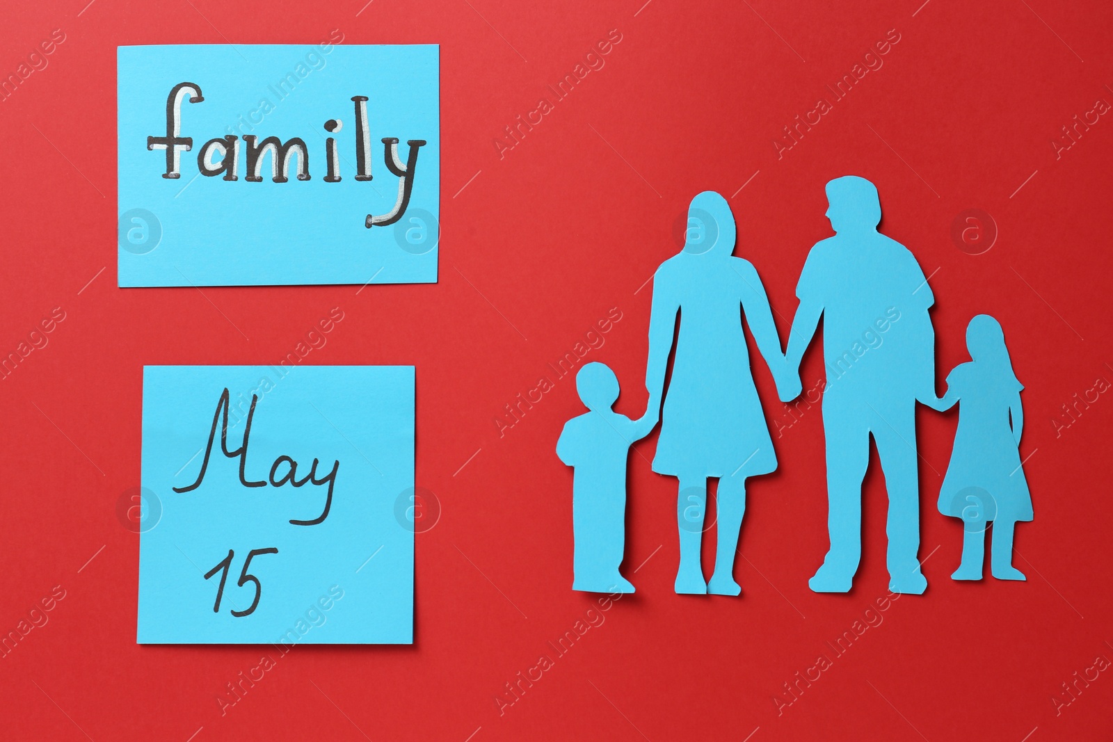 Photo of Family paper cutout and cards on red background, flat lay