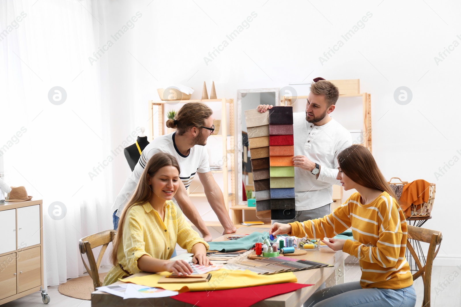 Photo of Fashion designers creating new clothes in studio