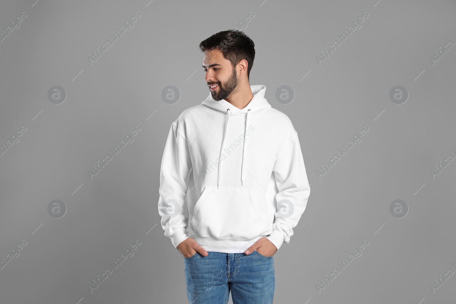 Photo of Portrait of young man in sweater on grey background. Mock up for design