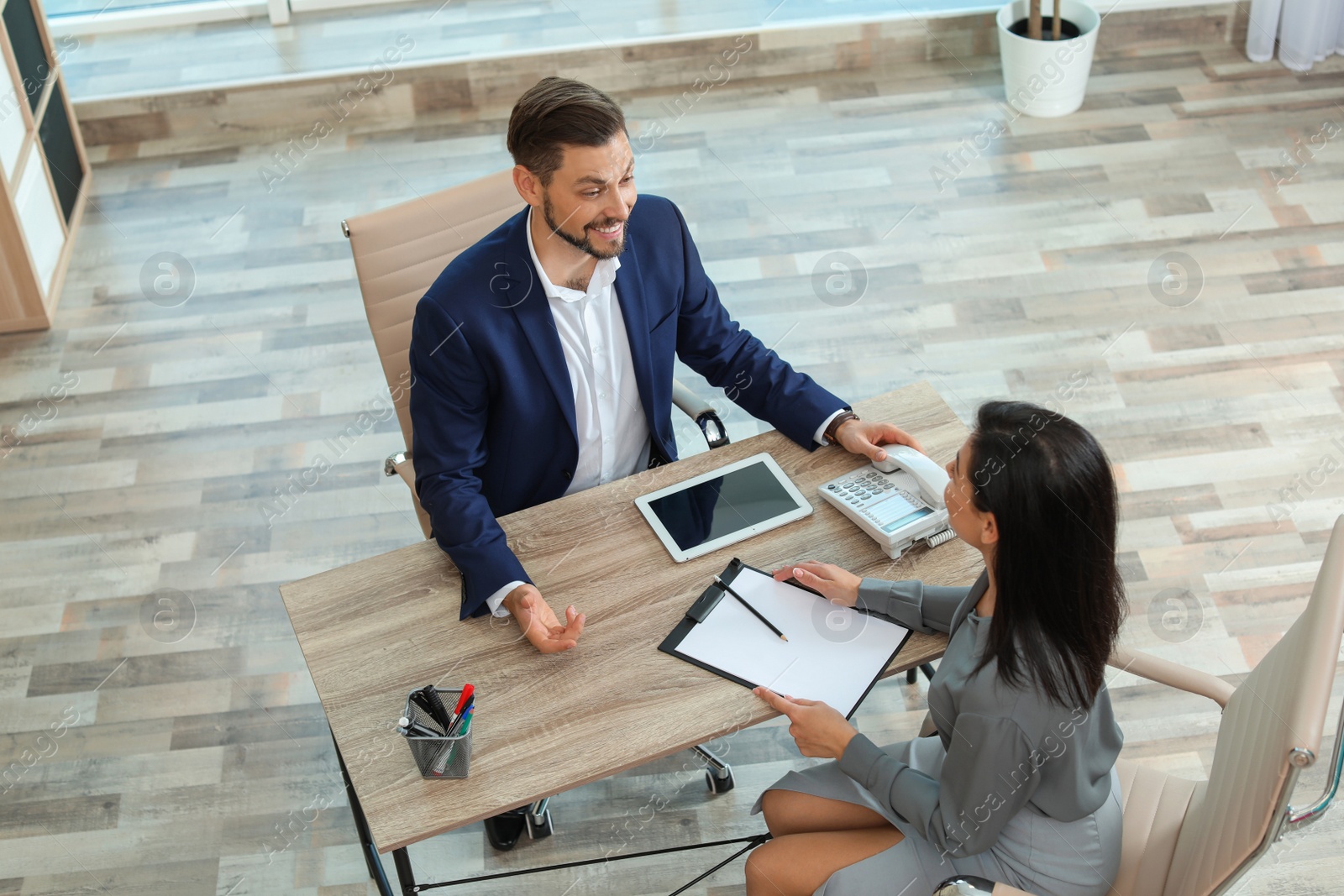 Photo of Human resources manager conducting job interview with applicant in office