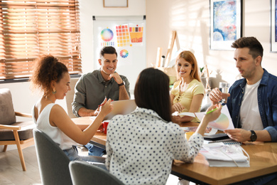 Team of professional designers working in office