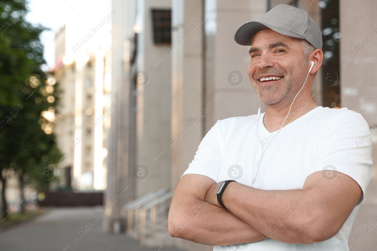 Photo of Handsome mature man in sportswear on street, space for text. Healthy lifestyle