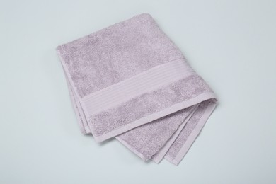 Photo of Violet terry towel on light grey background, top view