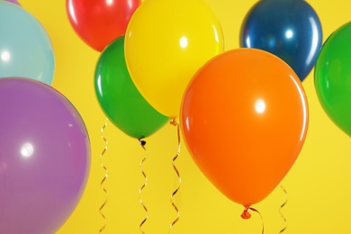 Bright balloons on color background. Celebration time