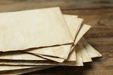 Photo of Stack of old letters on wooden table, closeup