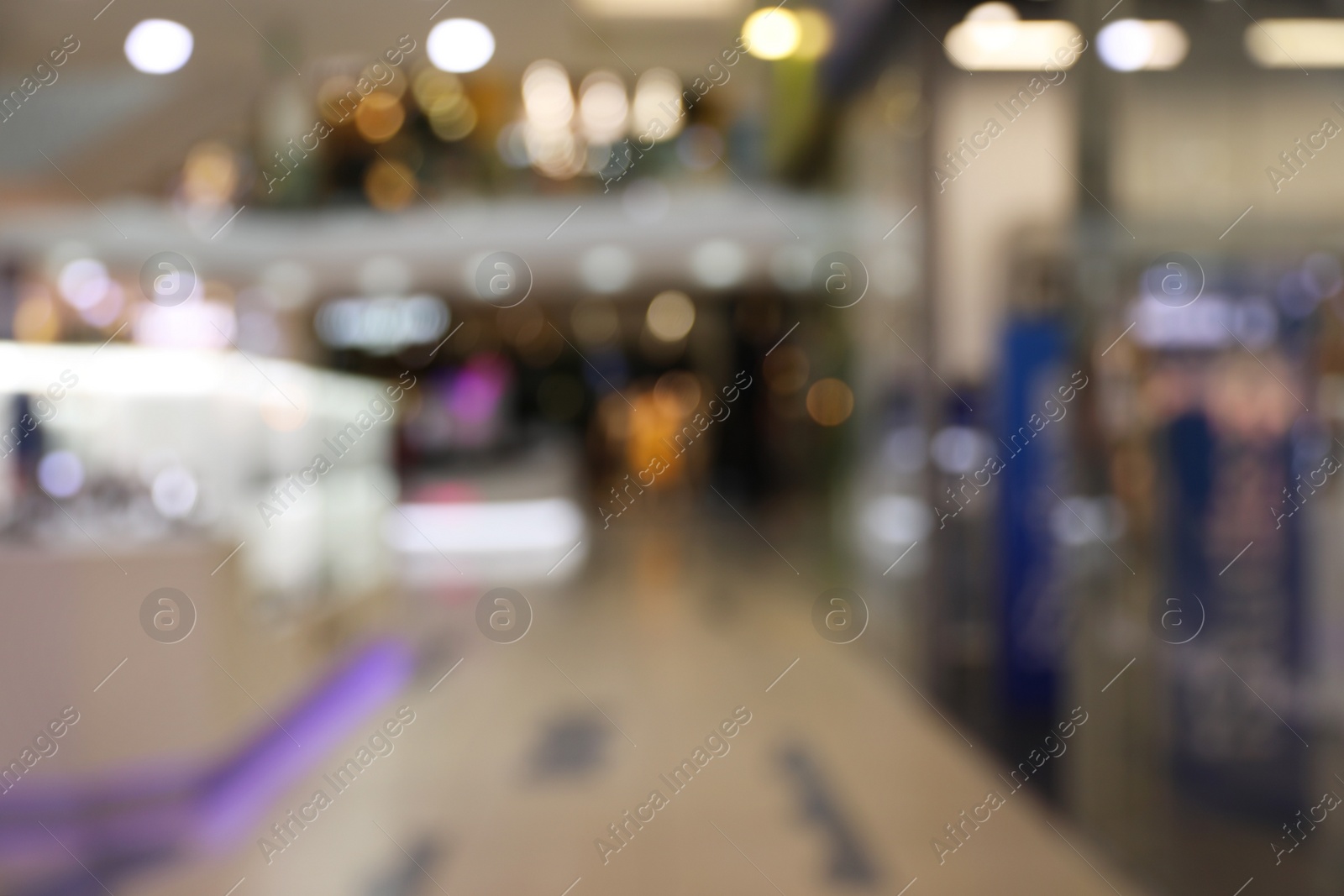 Photo of Blurred view of modern shopping mall interior. Bokeh effect