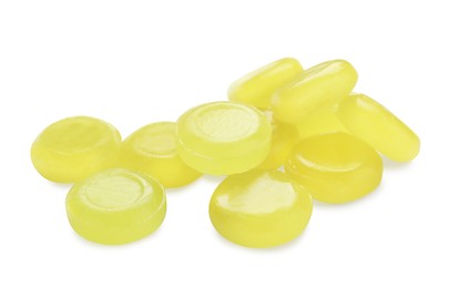 Photo of Many yellow cough drops on white background