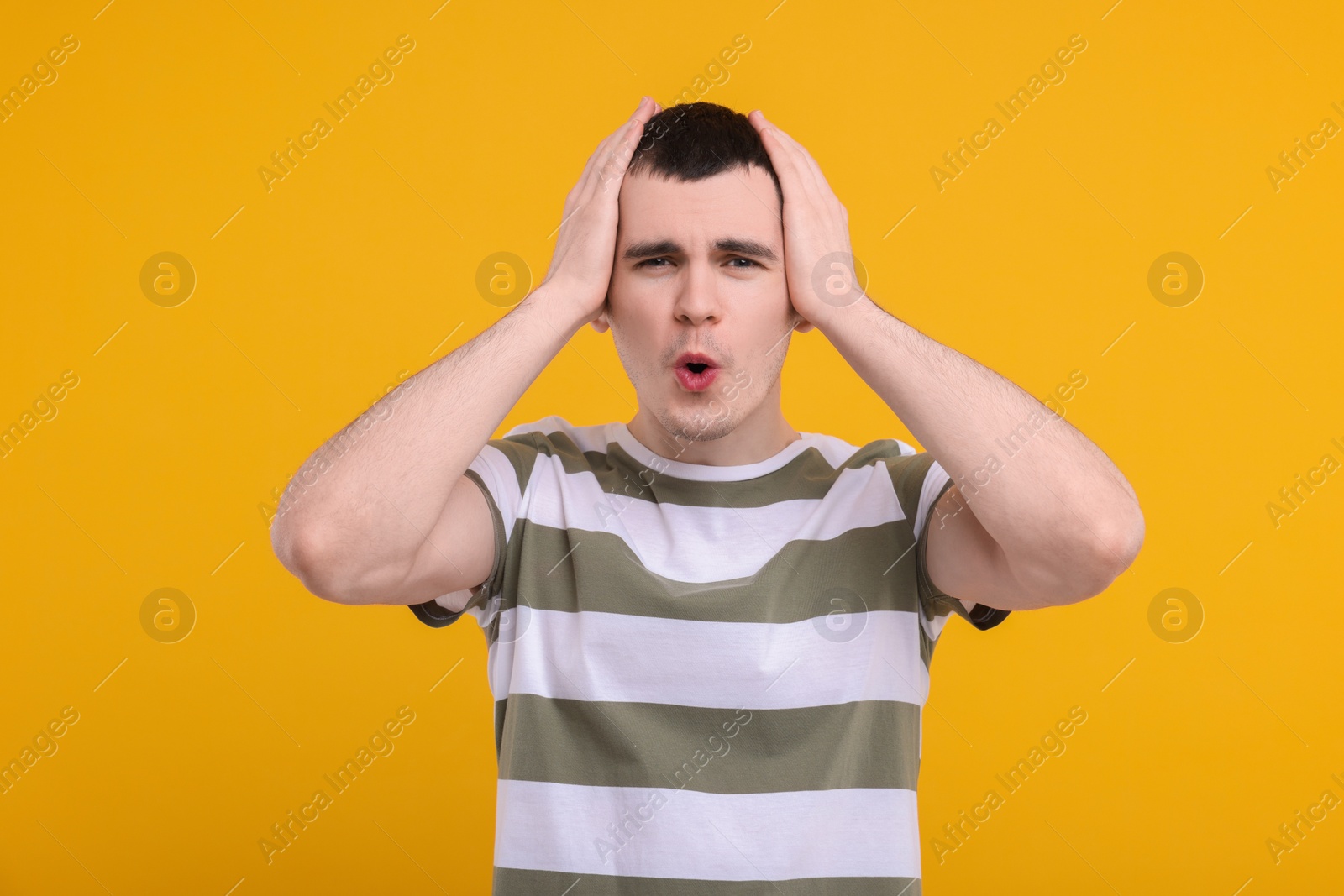 Photo of Portrait of surprised man on orange background