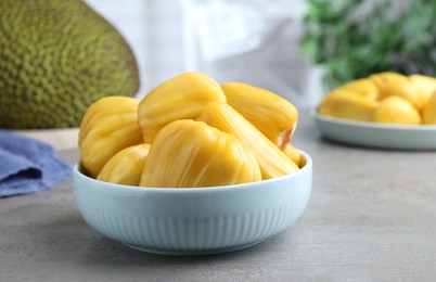 Fresh exotic jackfruit bulbs on light grey table