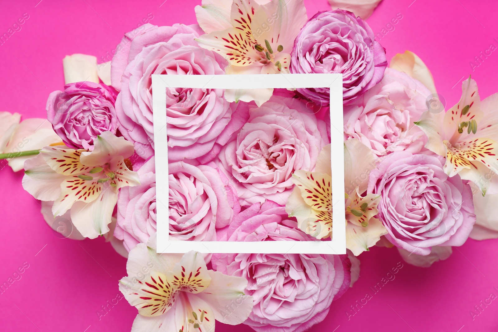 Photo of Frame with flowers on color background, top view. Space for text