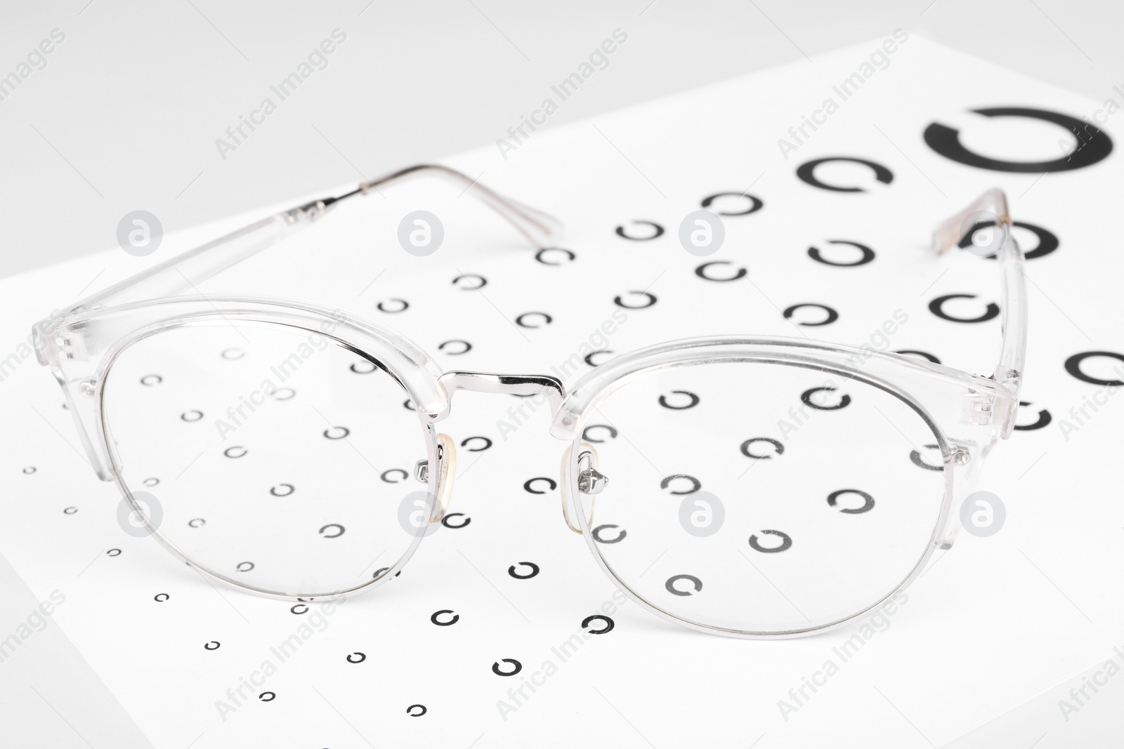 Photo of Glasses and vision test chart isolated on white