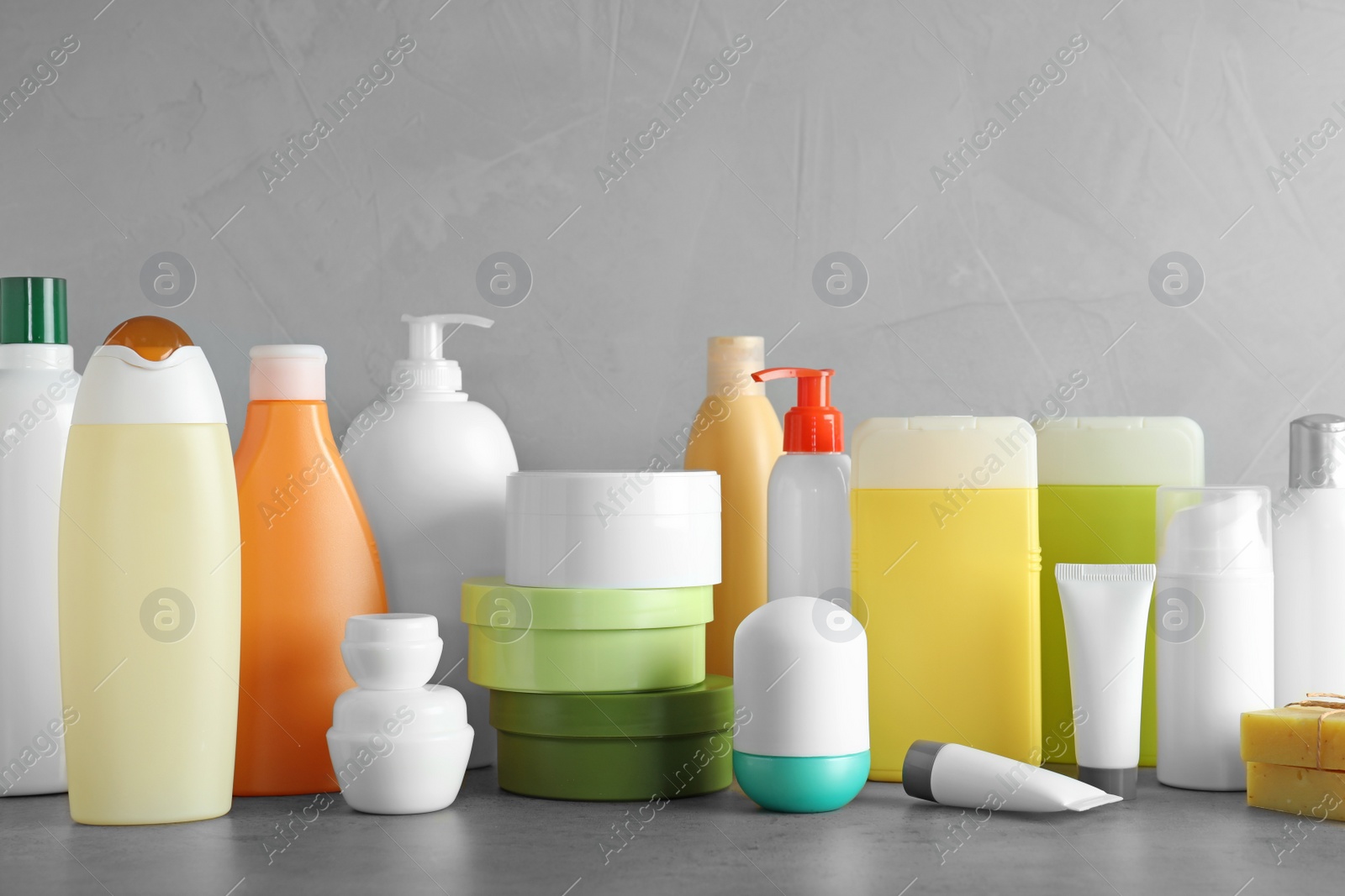 Photo of Different body care products on table against grey background