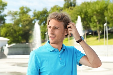 Portrait of handsome young man on street