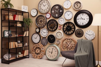 Photo of Stylish room interior with collection of wall clocks