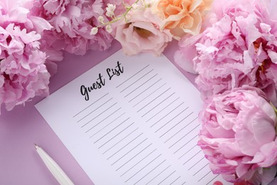 Guest list, pen and beautiful flowers on violet background, above view