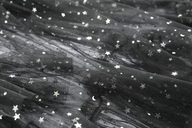 Photo of Beautiful black tulle fabric as background, closeup
