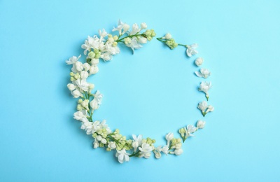 Photo of Flat lay composition with blossoming lilac flowers on color background. Space for text