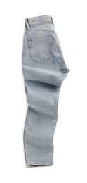 Photo of Rumpled light blue jeans isolated on white, top view. Stylish clothes
