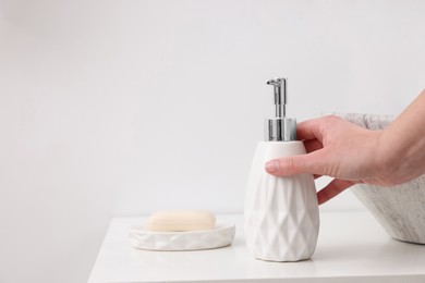 Photo of Bath accessories. Woman with container of cosmetic product indoors, closeup and space for text