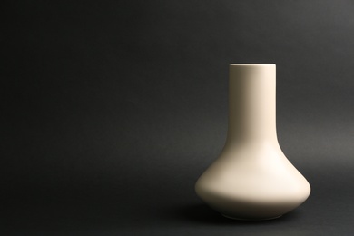 Photo of Stylish empty ceramic vase on black background, space for text