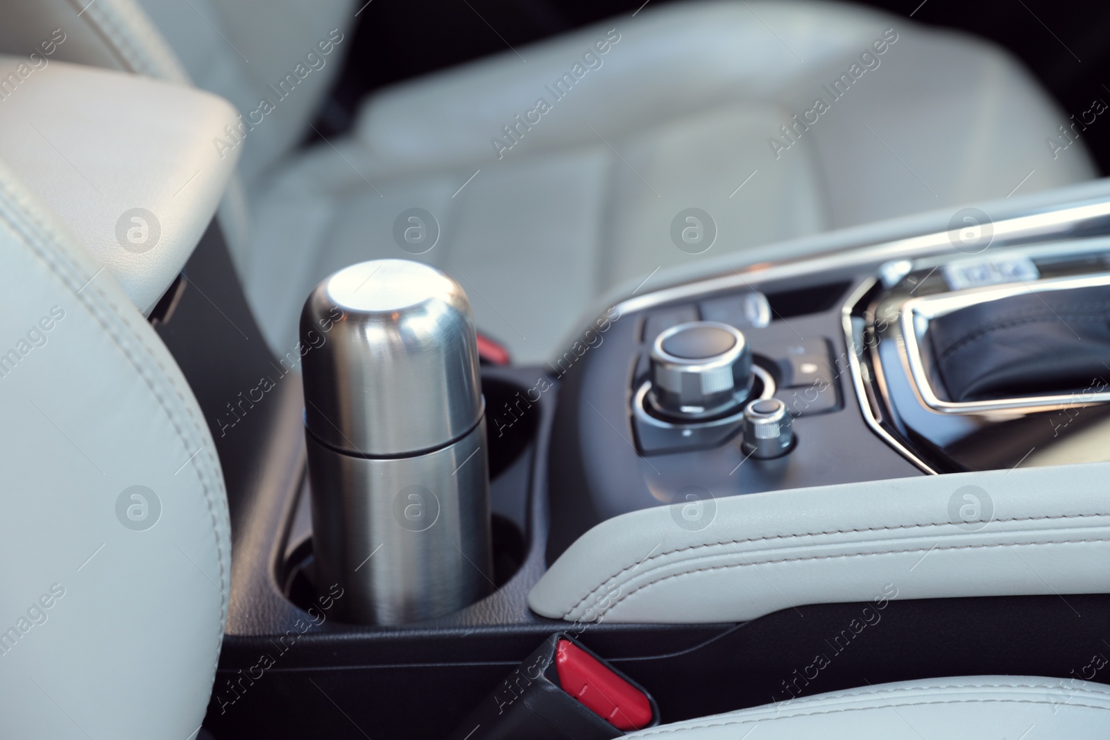 Photo of Silver thermos in holder inside of car